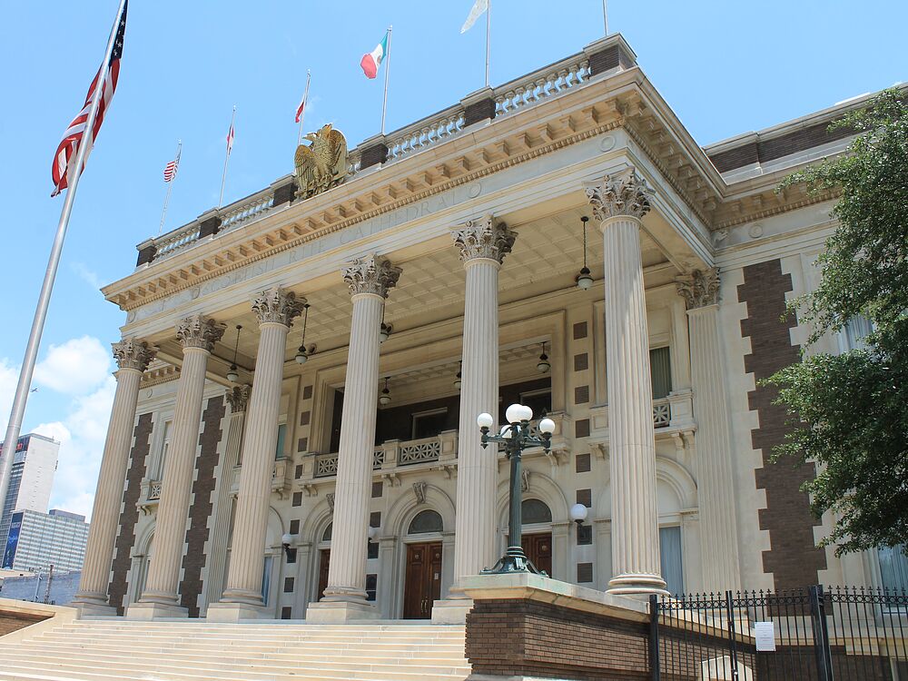 The Dallas Scottish Rite Cathedral's Corinthian portico and front steps, seen from Harwood Street beneath a summer sky.
